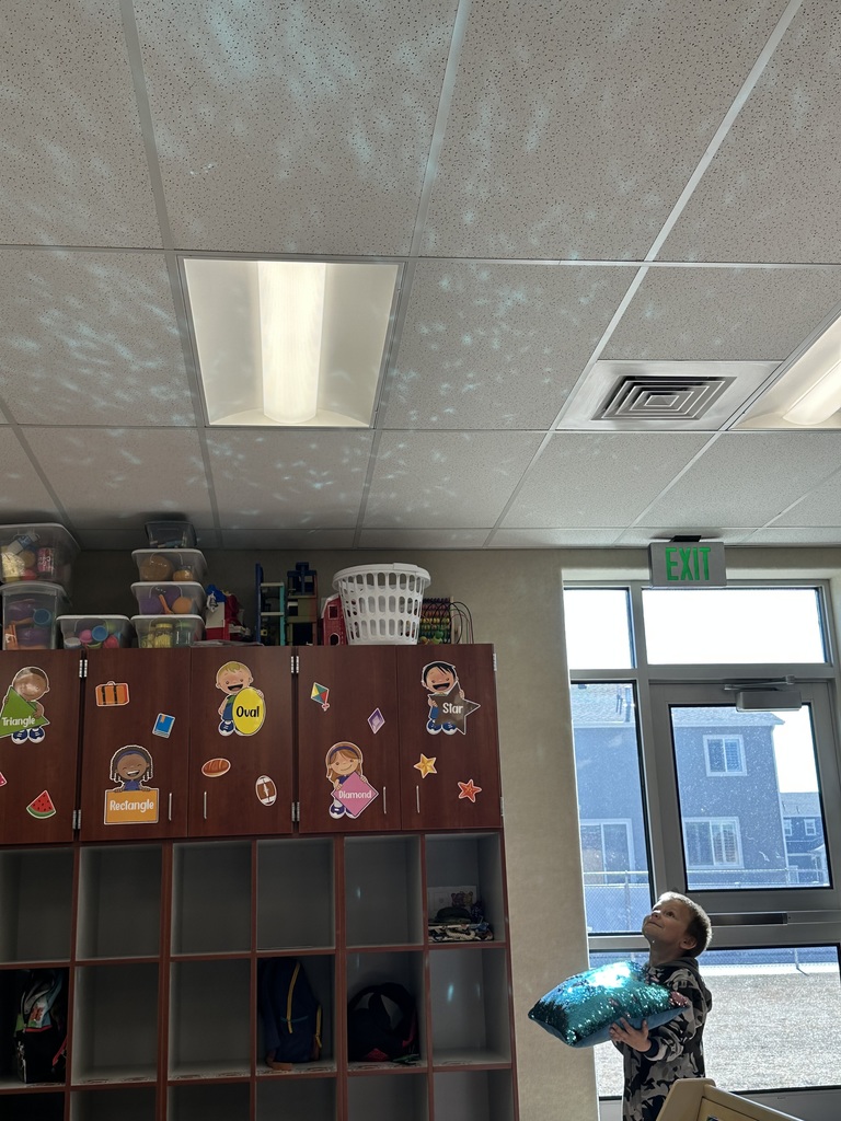 student looking at the reflection of a balloon