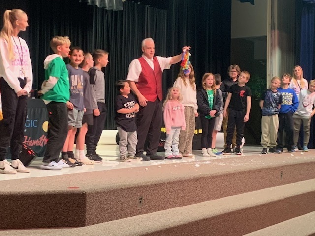 Magician with  a group of students.