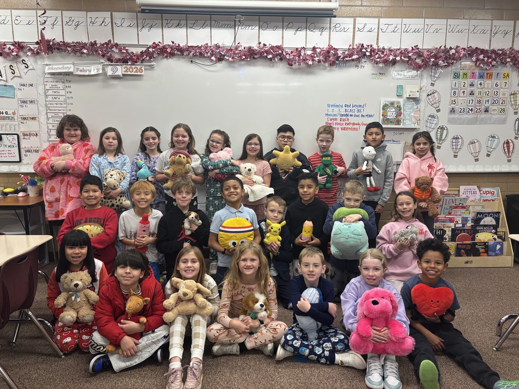 students posing in their pjs and and holding stuffed animals