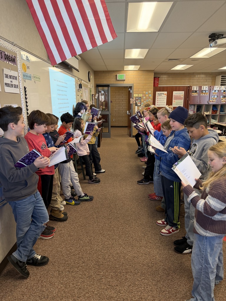 students in a line reading from their books