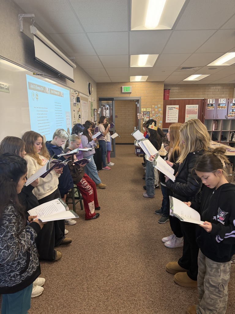 students in a line reading from their books