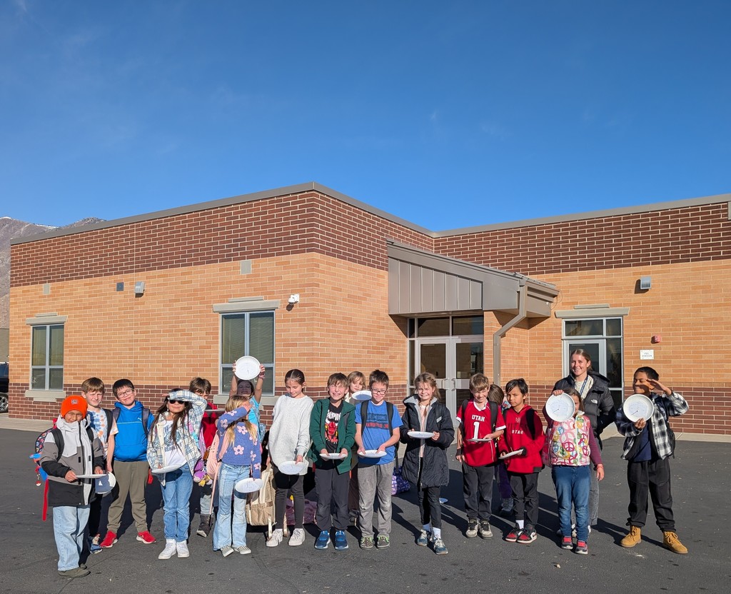 fourth grader posing with their homemade sundials