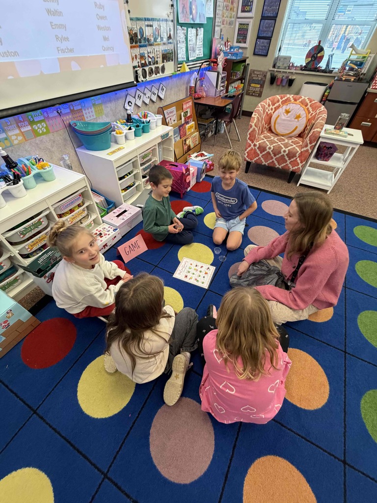 Students playing a game with a parent helper.
