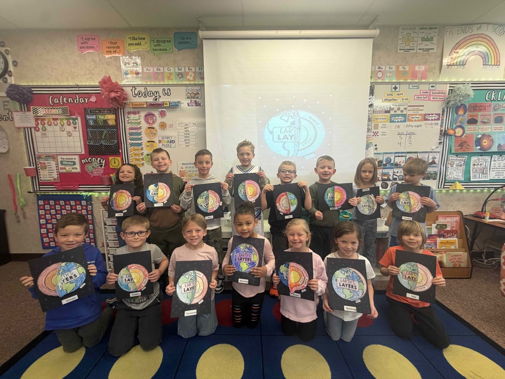 Students showing their diagrams of the earth's crust.