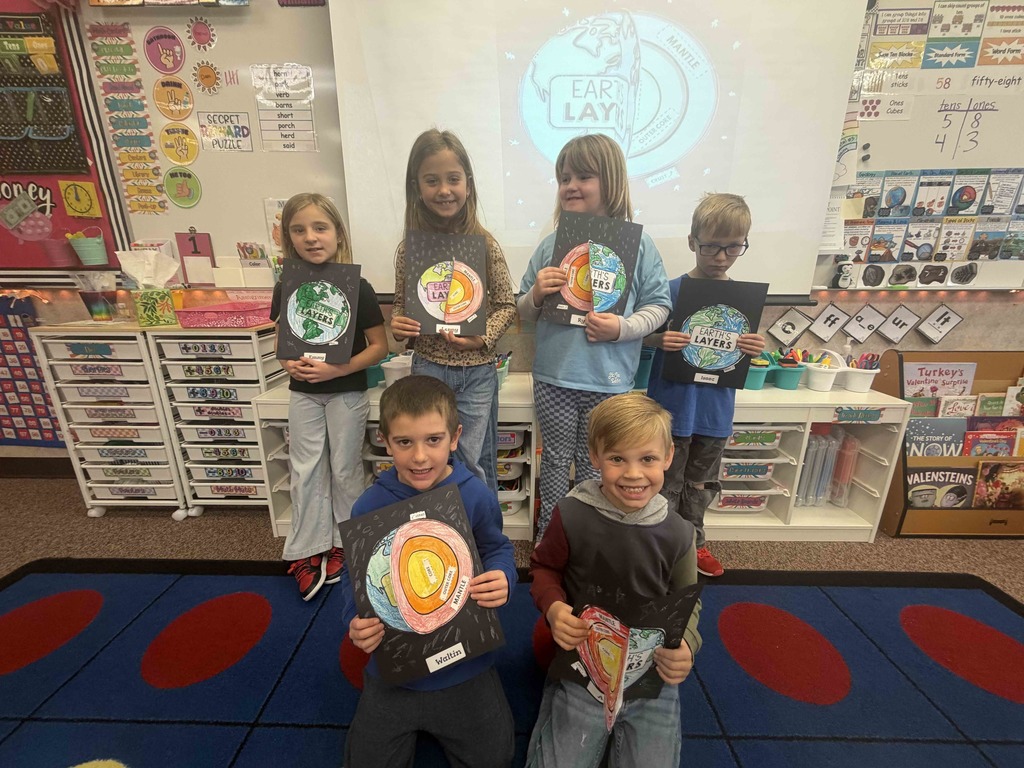 Students showing their diagrams of the earth's crust.