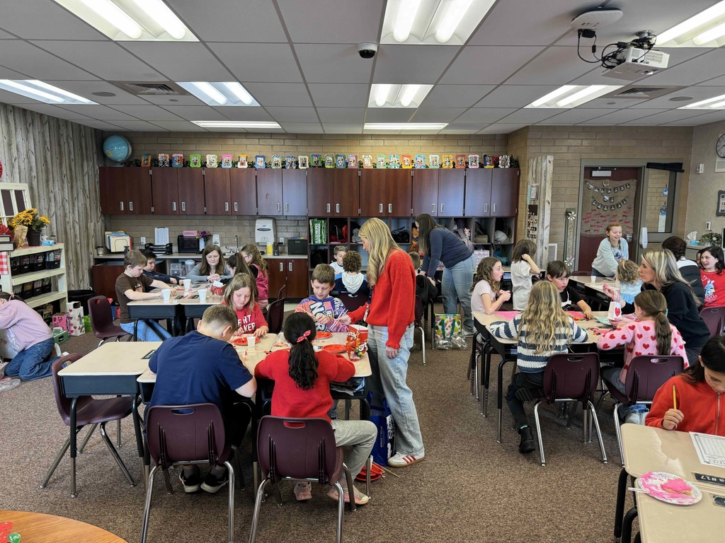 Students at desks participating in various activities.