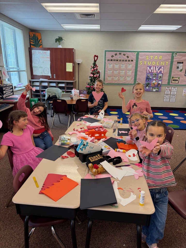 Second grade students making a Valentine's Day craft.