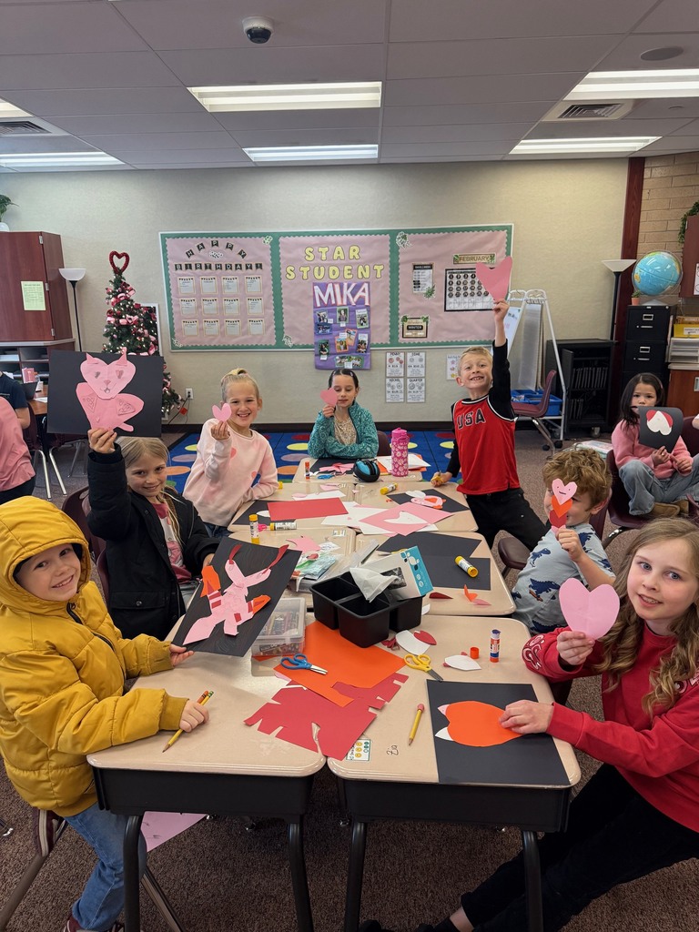 Second grade students making a Valentine's Day craft.