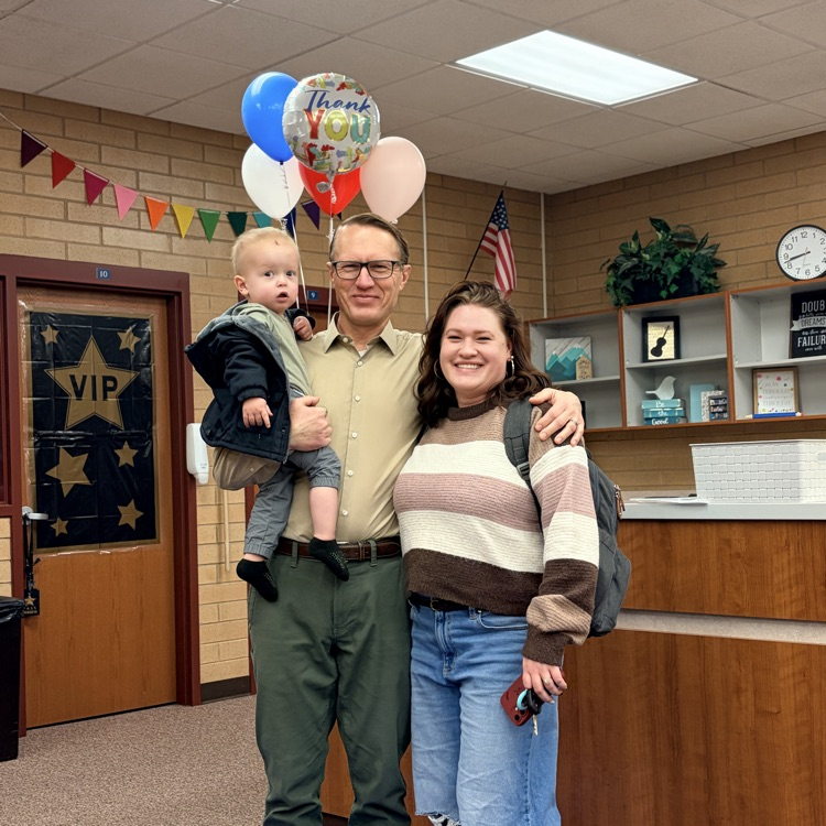 Mr Ewell standing with his daughter and grandchild 