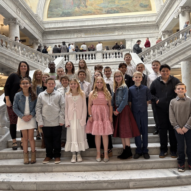 a class standing on the steps of the Utah state capitol 