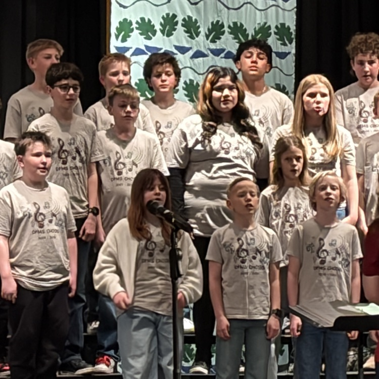 students on risers singing