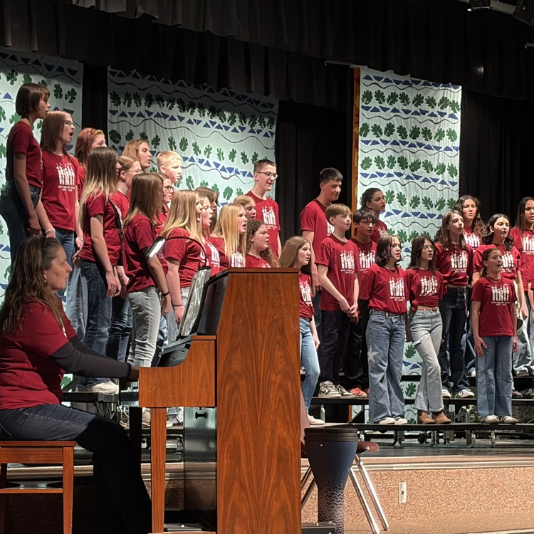 picture from stage right of students singing on risers 