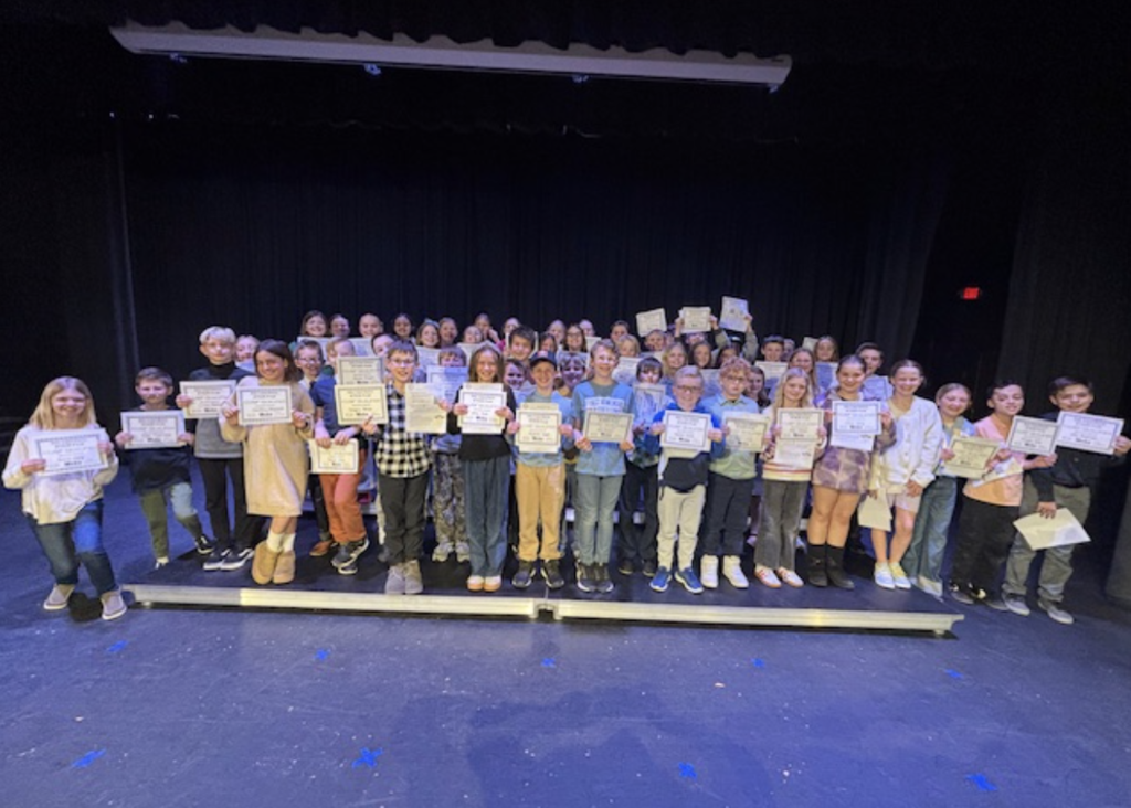 Students holding their certificates.