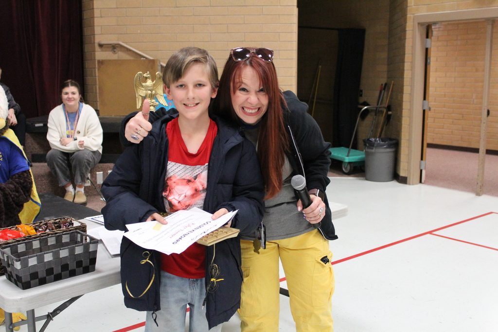 Mrs. Farr giving the Golden Key board to a student
