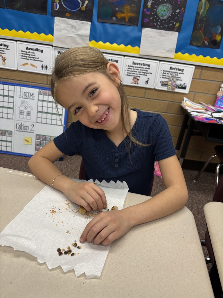 student posing with their cookie
