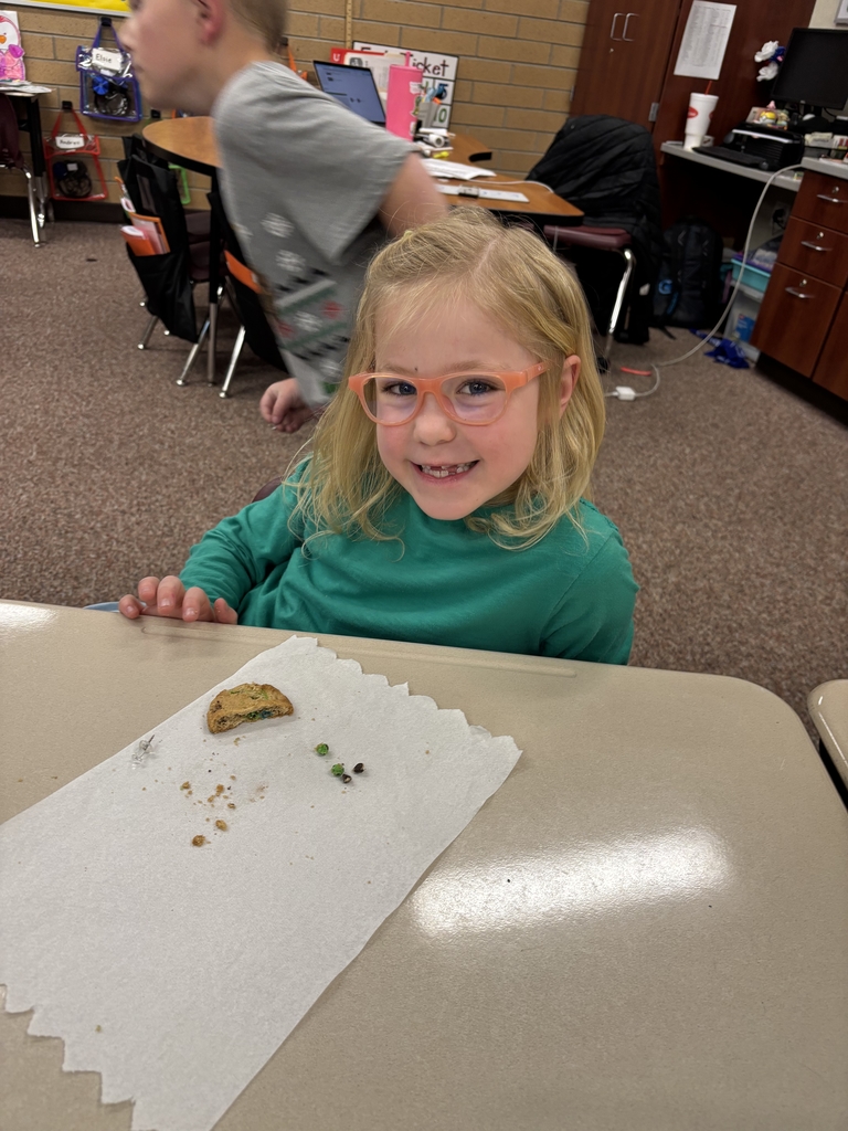 student posing with their cookie