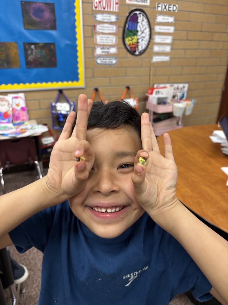 student posing with their cookie