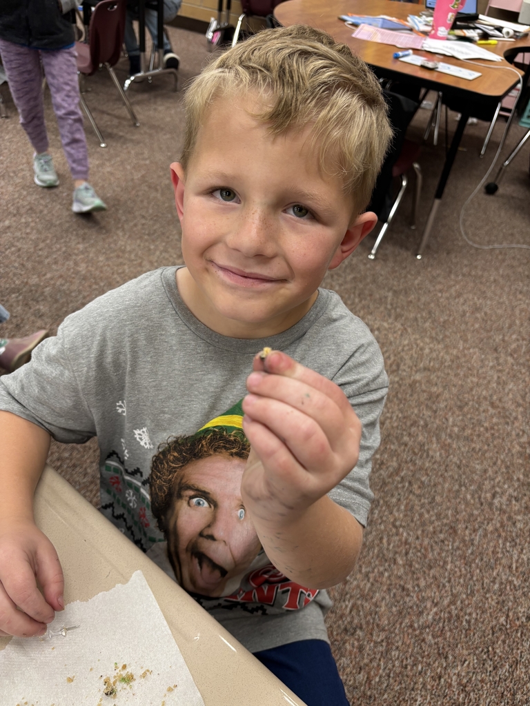 student posing with their cookie