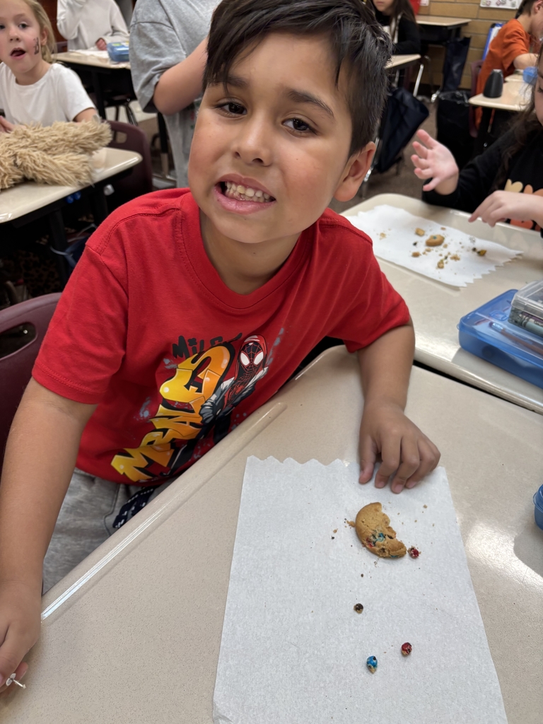 student posing with their cookie