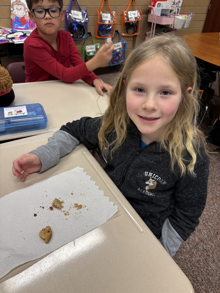 student posing with their cookie