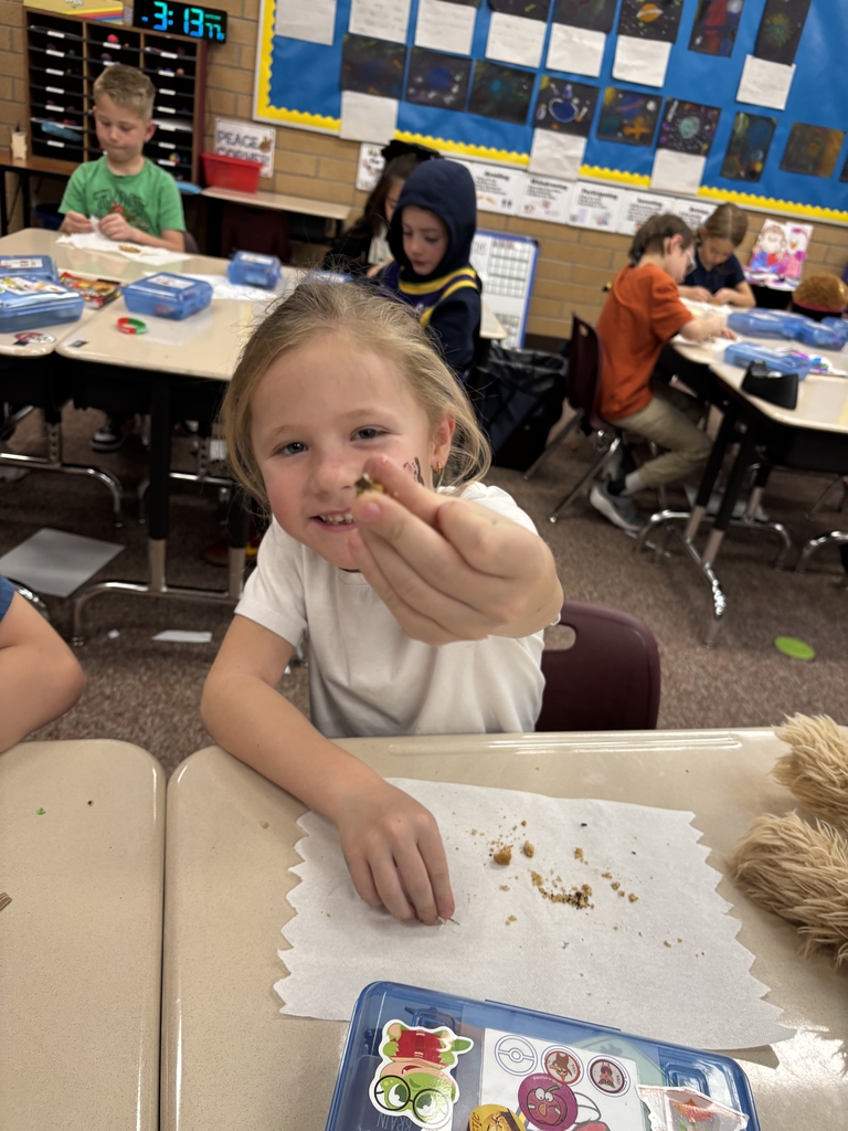 student posing with their cookie