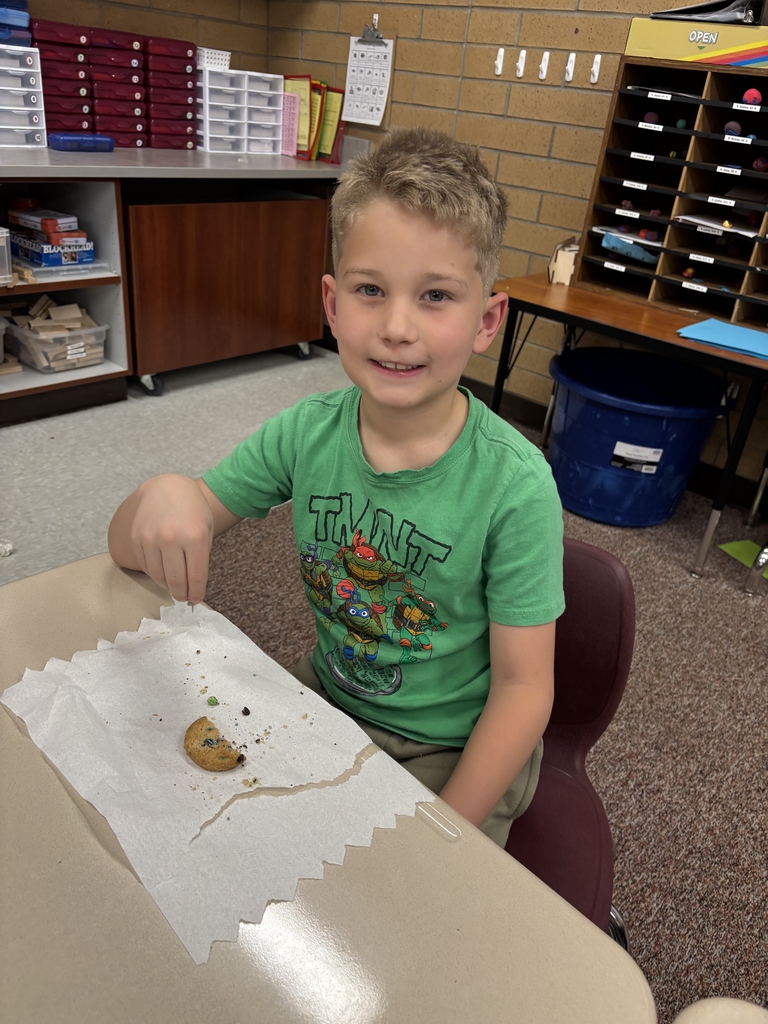 student posing with their cookie