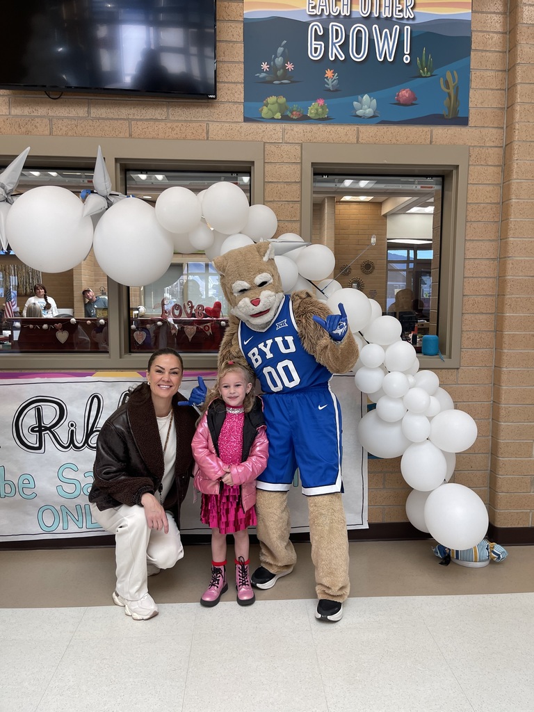 Cosmo posing with Mrs. Steiner (assistant principal) and a student.