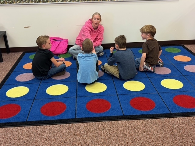 Students in a group listening to a UVU nursing student.