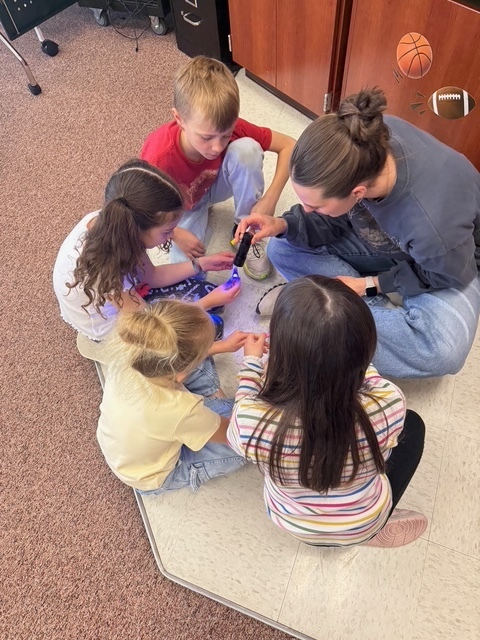 Students learning about germs from a UVU nursing student.
