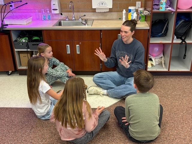 Students in a group listening to a UVU nursing student.
