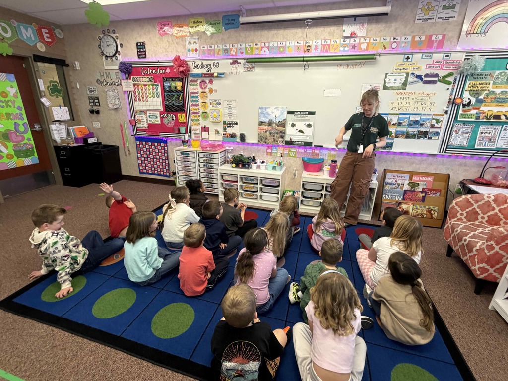 Students listening to a lesson by a Red Butte Garden employee.