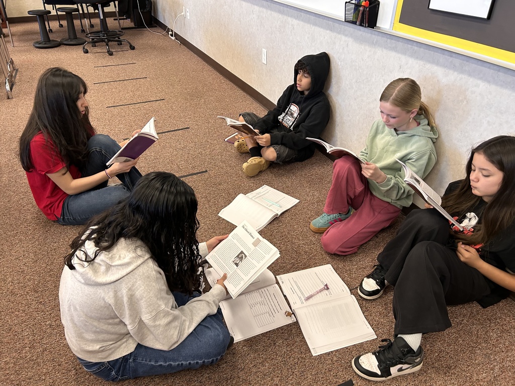 students reading on the floor