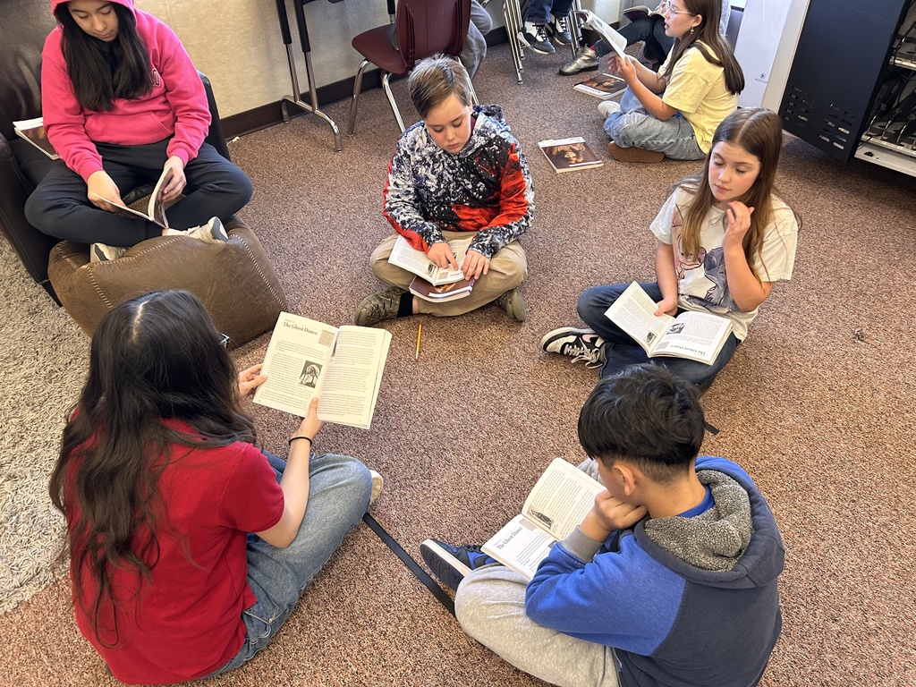 students reading on the floor