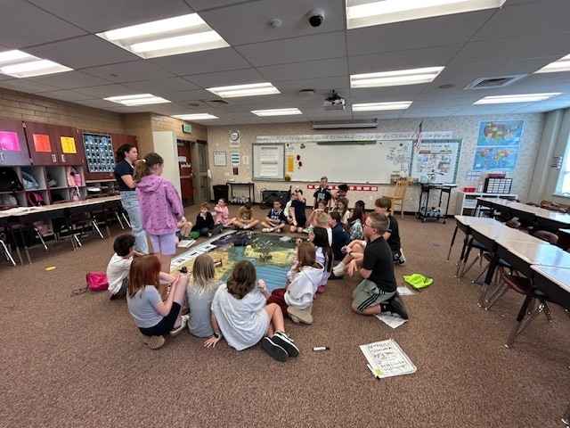 Students working as a group with a USU employee.