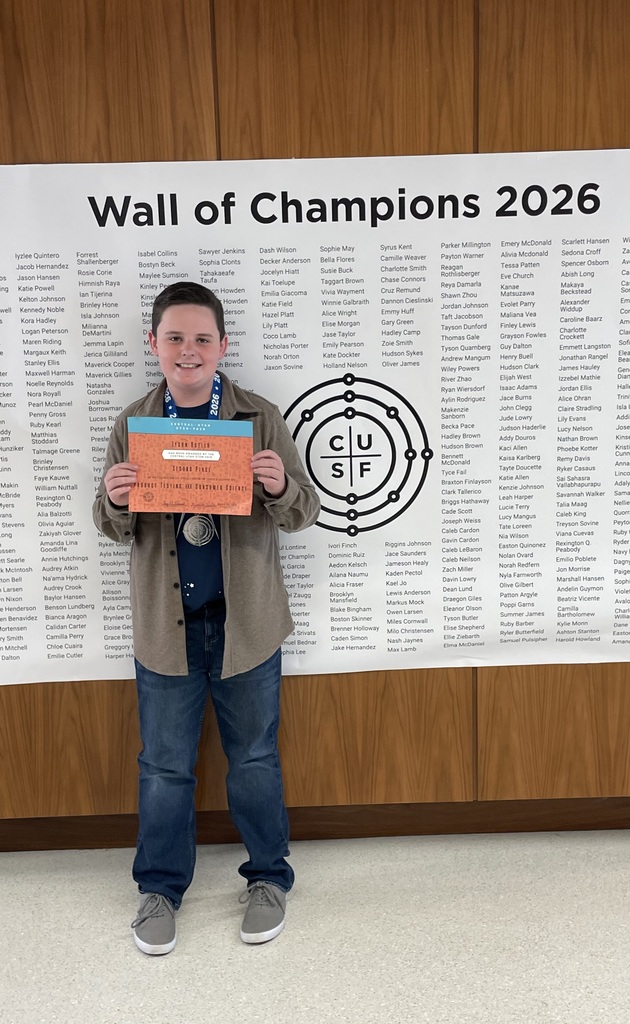 Tyson Butler holding up his science fair awards.