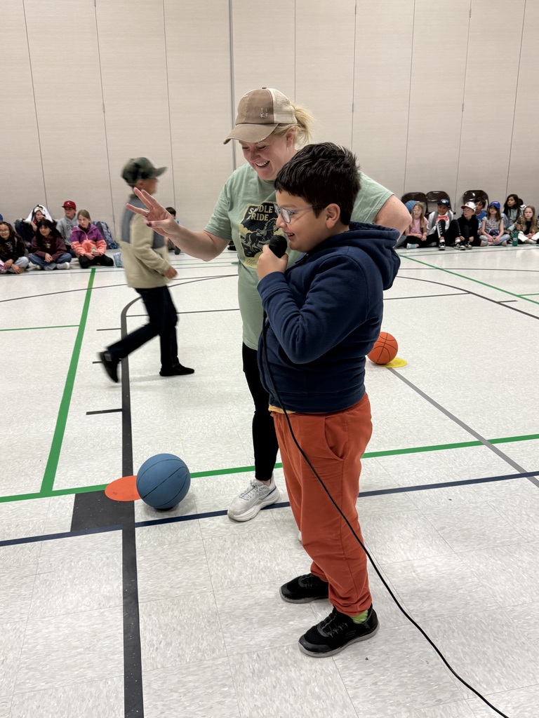 students shooting basketballs with teachers