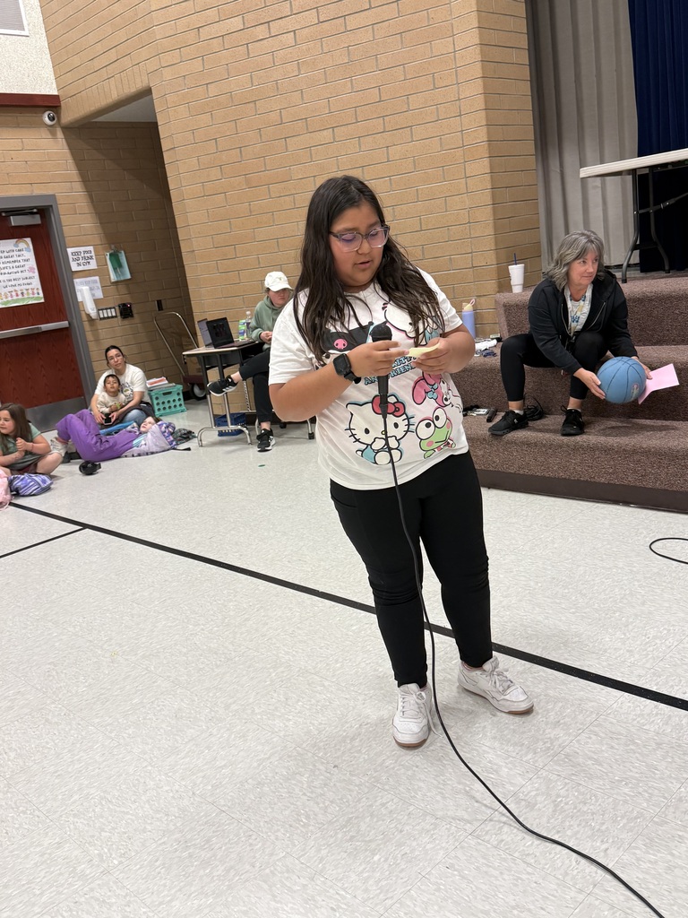 students shooting basketballs with teachers