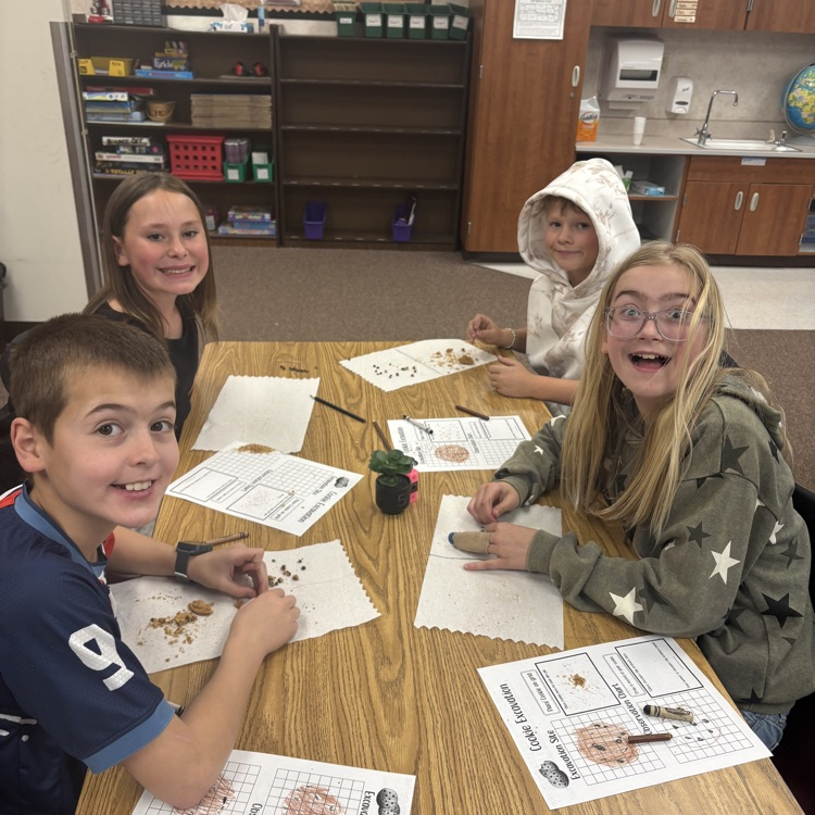 four students with crushed cookies