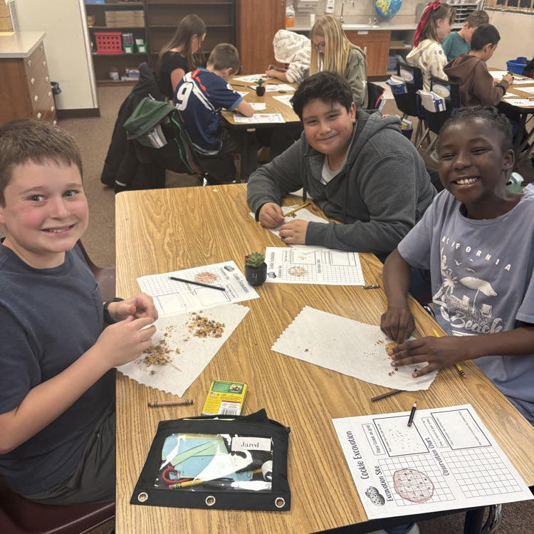 three students with crushed cookies