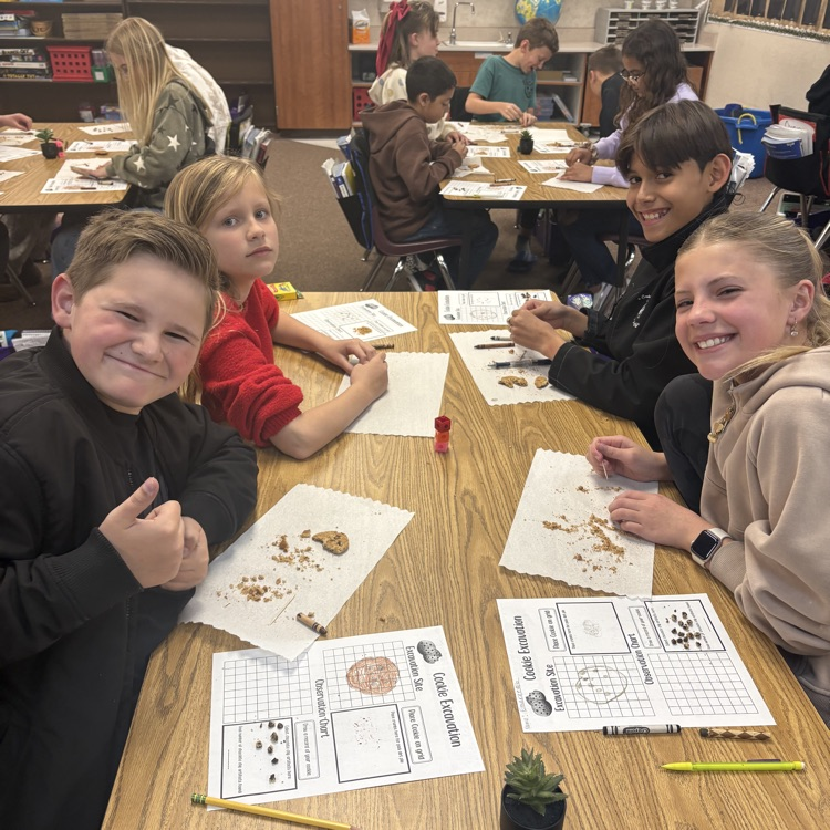 four students with crushed cookies