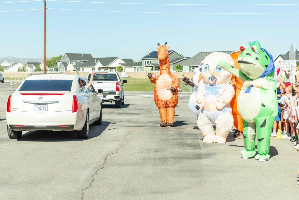 Blow up characters waving to the limo.