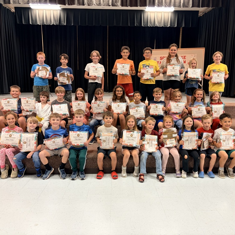 a group of students holding student of the month certificates