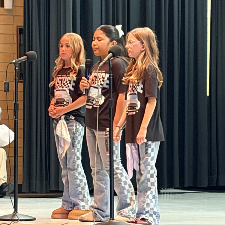 3 girls dressed in black shirts and jeans singing