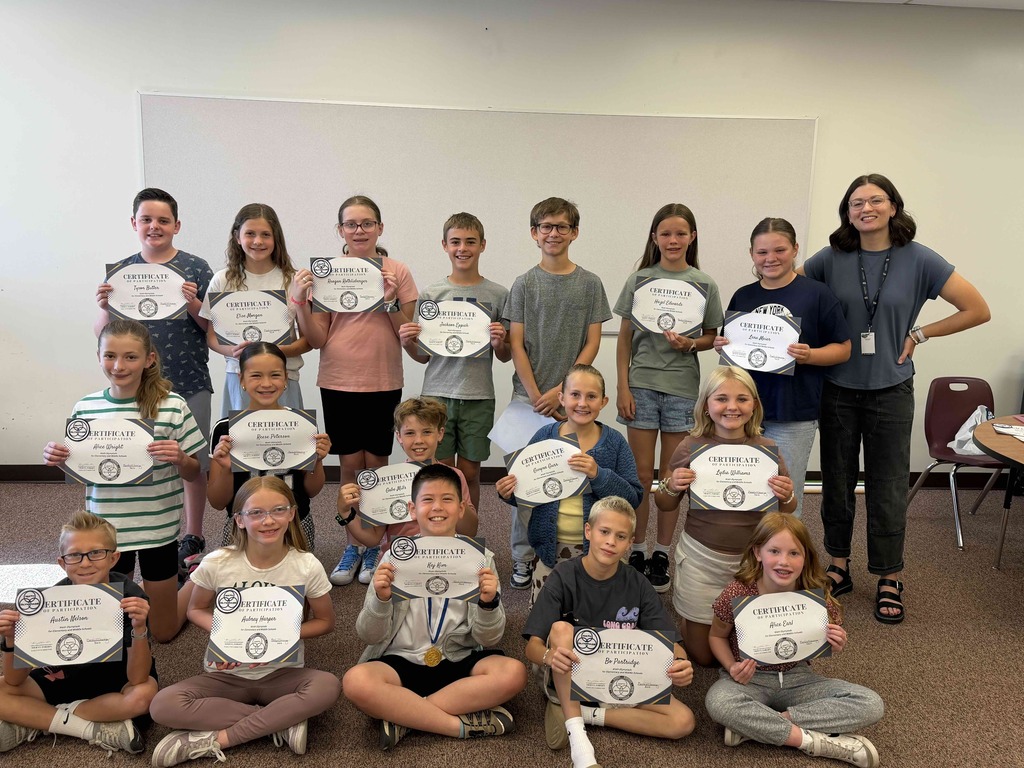 Maple Ridge Mathletes with Riley Wolfgramm (Mathlete Coach), holding their certificates.