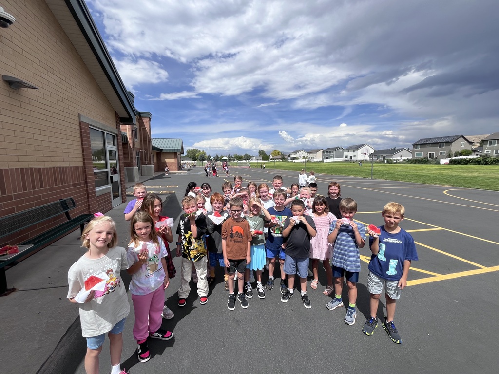 third graders eating watermelon on the playground