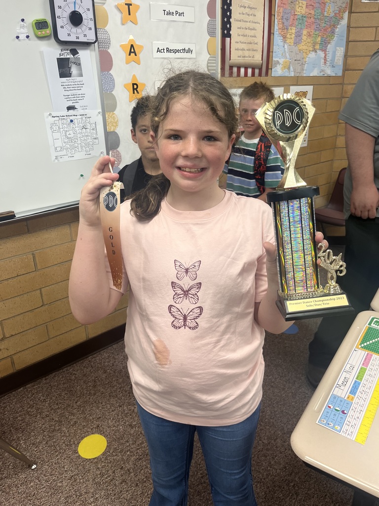 Student shows her ribbon and trophy