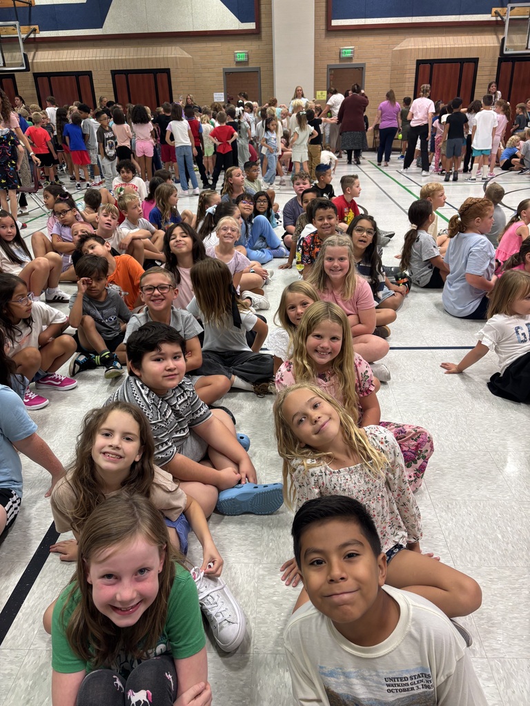 students smiling at the assembly 