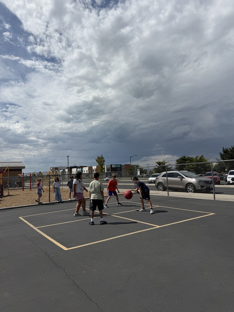 students playing four square