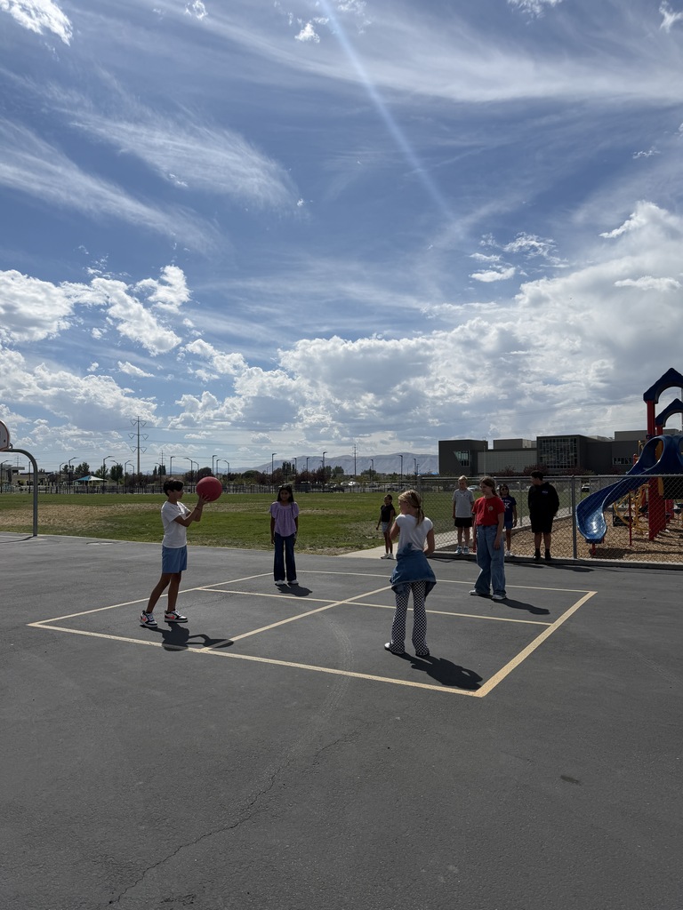 students playing four square