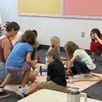 kids playing with cars and track
